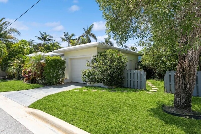 view of side of home with a garage and a yard