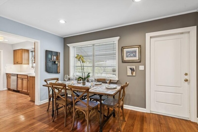 dining room with hardwood / wood-style flooring and sink