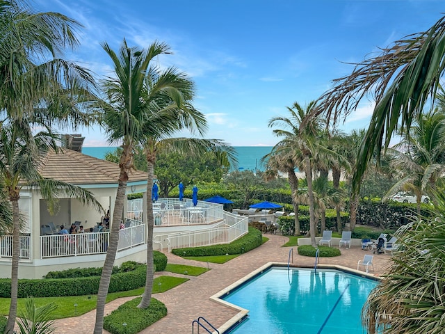 view of pool with a patio area and a water view