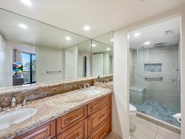 bathroom featuring tile patterned floors, toilet, an enclosed shower, and vanity