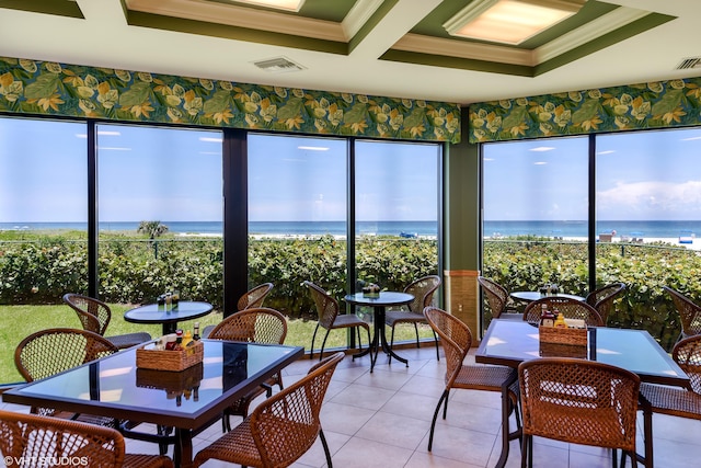 sunroom featuring a water view