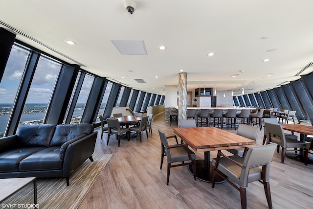 dining area featuring hardwood / wood-style floors and expansive windows