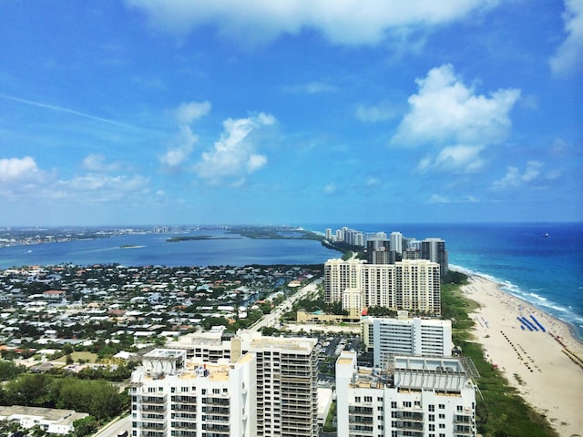 drone / aerial view with a beach view and a water view