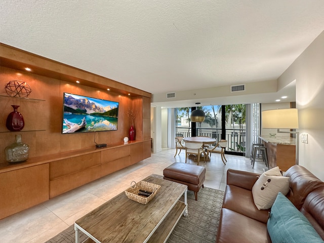 living room featuring light tile patterned flooring and a textured ceiling