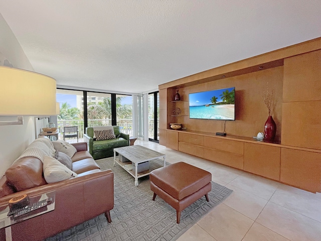 living room with expansive windows, light tile patterned floors, and a textured ceiling