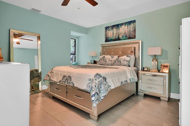 bedroom with ceiling fan and light tile patterned flooring