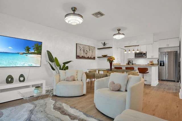 living room with light hardwood / wood-style floors