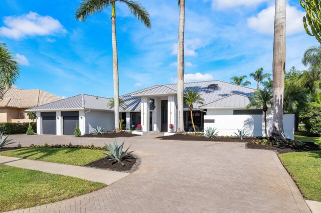 view of front of house featuring a front yard and a garage