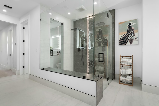 bathroom featuring tile patterned floors, toilet, and an enclosed shower