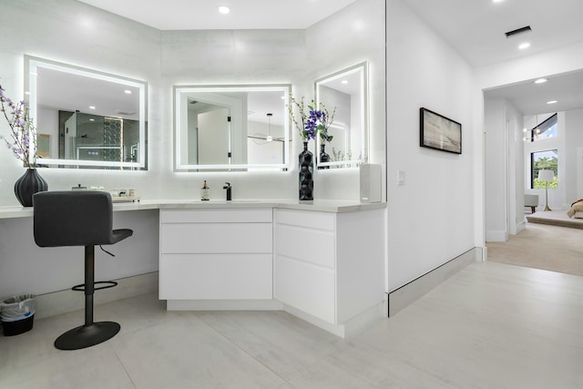 bathroom with vanity and a shower with shower door