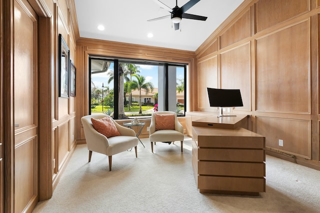 living area featuring ceiling fan, wood walls, light colored carpet, and lofted ceiling