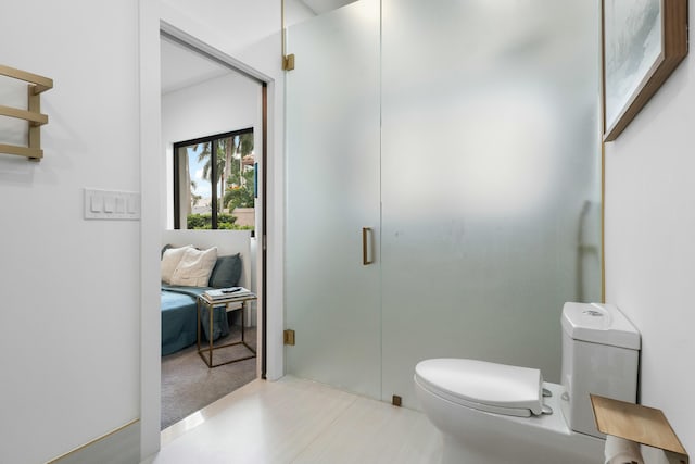 bathroom with toilet and an enclosed shower