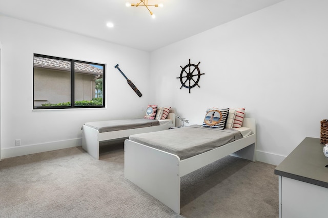 carpeted bedroom with a chandelier