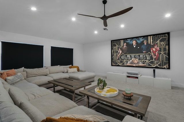 carpeted home theater with ceiling fan