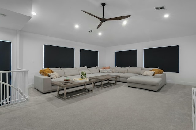 carpeted living room featuring ceiling fan