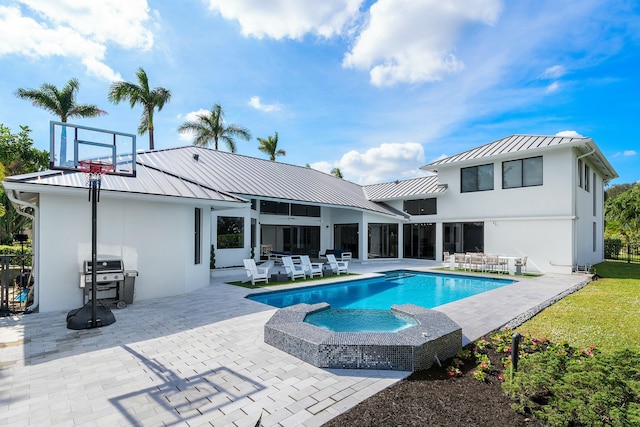 rear view of property featuring a patio area