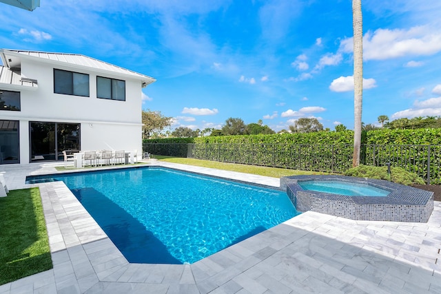 view of pool with an in ground hot tub and a patio