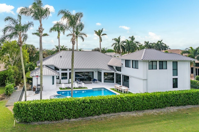 back of house featuring a fenced in pool and a patio area