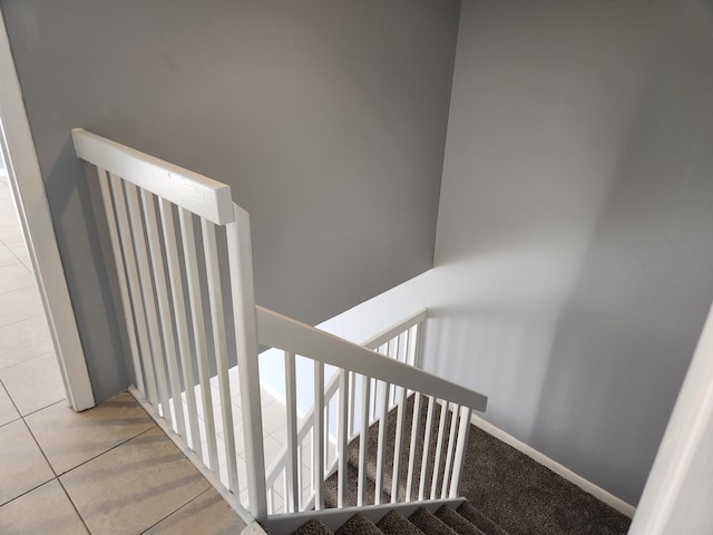 stairway with tile patterned floors