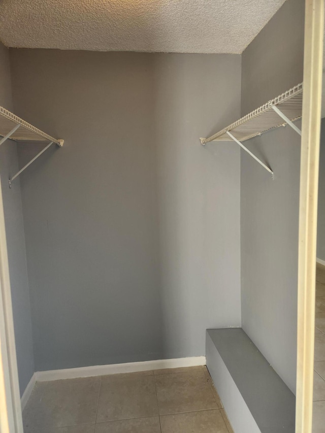 spacious closet with tile patterned floors