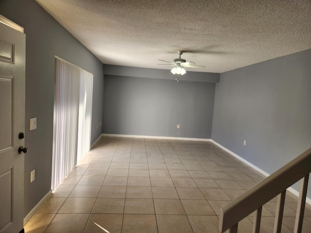 unfurnished room with light tile patterned floors, a textured ceiling, and ceiling fan