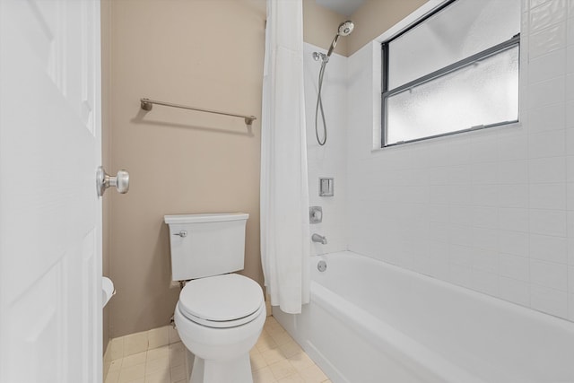 bathroom featuring tile patterned flooring, toilet, and shower / tub combo