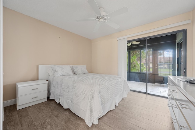 bedroom with access to exterior, ceiling fan, and hardwood / wood-style flooring