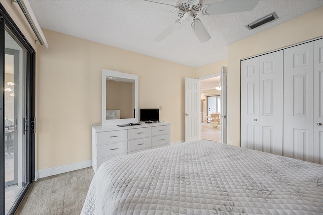 bedroom with ceiling fan, access to exterior, multiple windows, and light hardwood / wood-style flooring