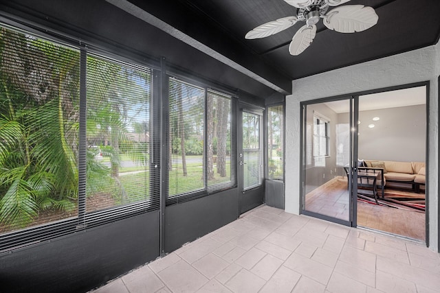 sunroom / solarium featuring ceiling fan