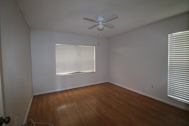 spare room featuring dark hardwood / wood-style floors and ceiling fan