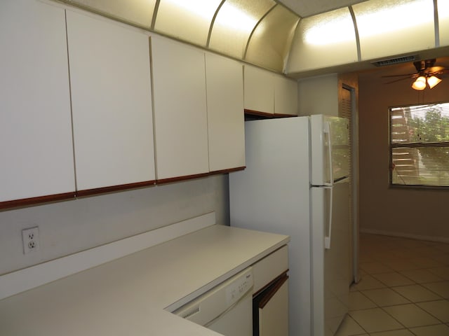 kitchen featuring ceiling fan, white appliances, light tile patterned floors, and white cabinets