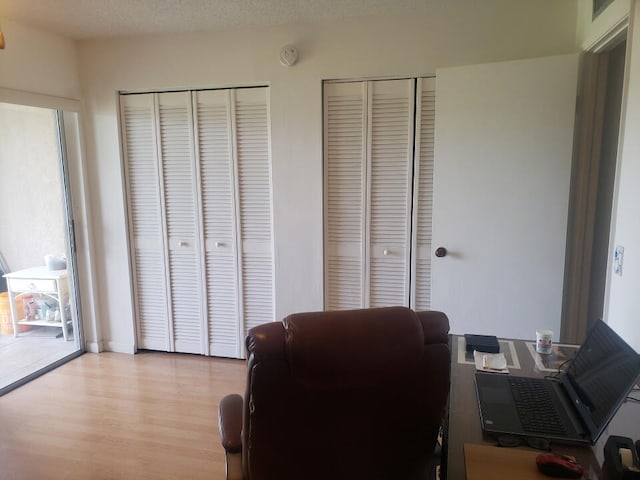 office area featuring light hardwood / wood-style floors and a textured ceiling