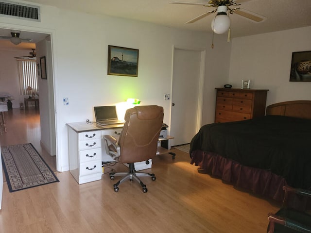 bedroom with light hardwood / wood-style floors and ceiling fan