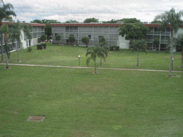 view of property's community with a yard