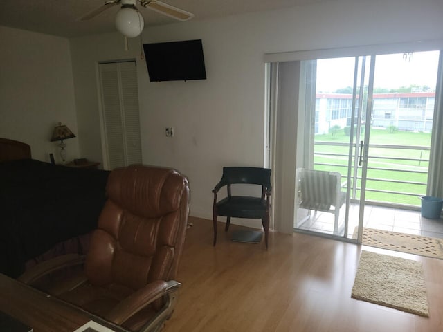 bedroom featuring light wood-type flooring, access to outside, a closet, and ceiling fan