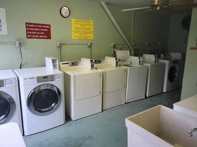 washroom featuring washing machine and dryer, ceiling fan, and sink