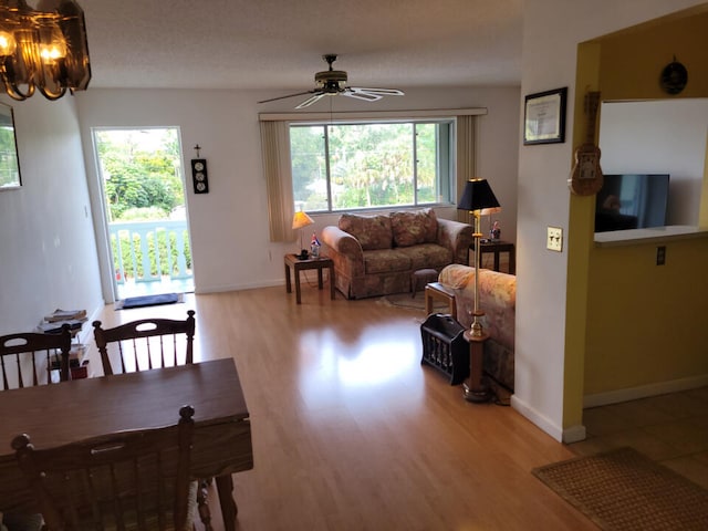 living room with light hardwood / wood-style floors and ceiling fan