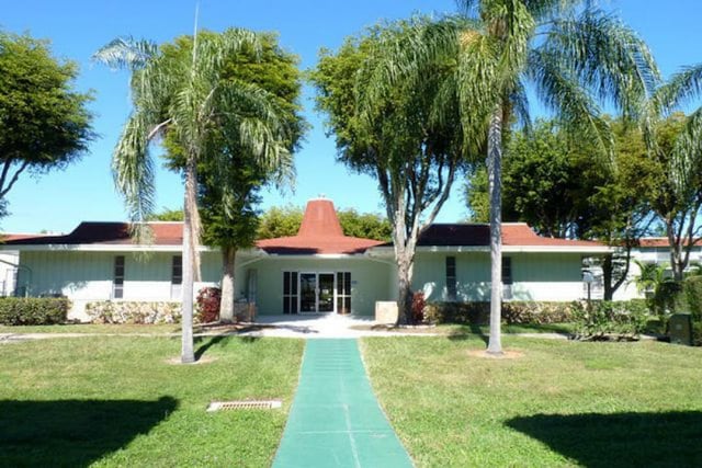 rear view of property featuring a lawn