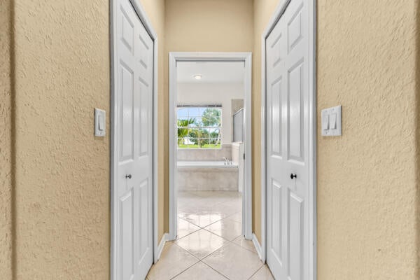 hallway featuring light tile patterned flooring