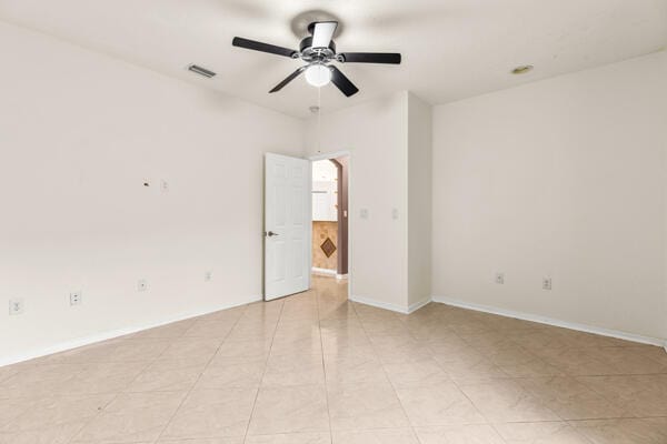 tiled empty room with ceiling fan