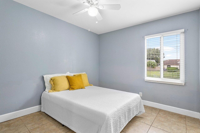 bedroom with ceiling fan and light tile patterned floors