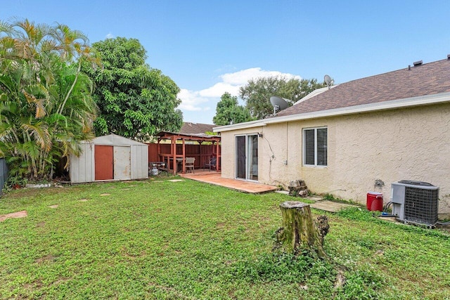 view of yard with a patio, a shed, and central AC unit