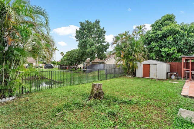 view of yard with a water view and a shed