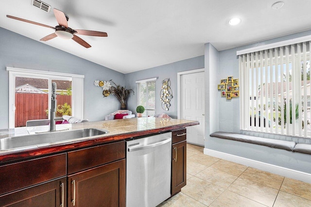 kitchen featuring lofted ceiling, sink, stainless steel dishwasher, ceiling fan, and light tile patterned floors