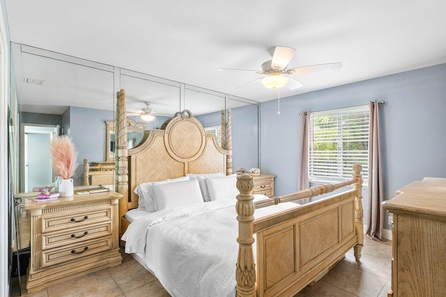 tiled bedroom featuring ceiling fan