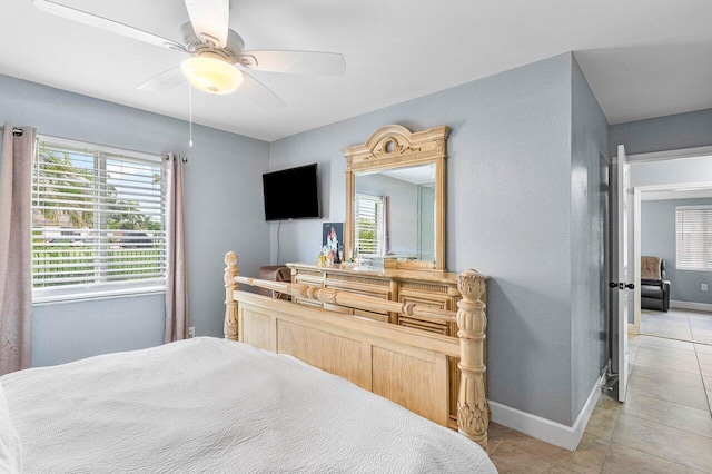 bedroom with ceiling fan and light tile patterned floors