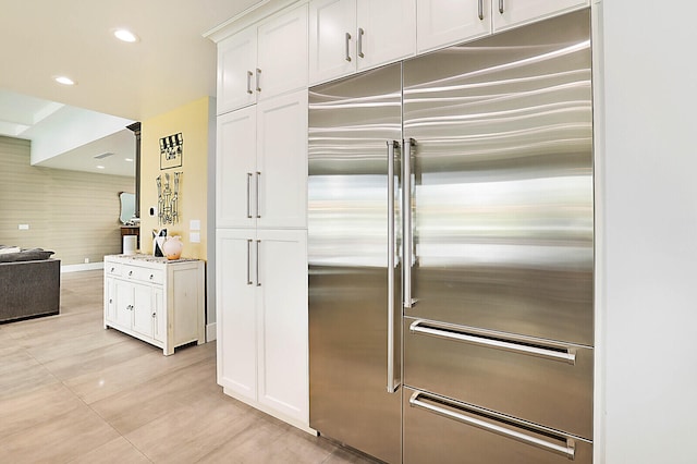 kitchen featuring white cabinetry and built in refrigerator