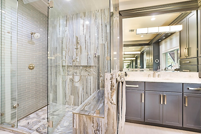 bathroom with vanity and a shower with door