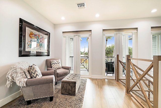 living area with light hardwood / wood-style flooring