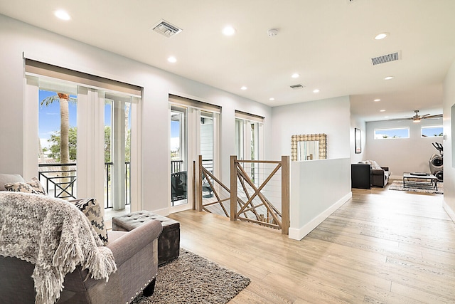 living room featuring ceiling fan and light wood-type flooring